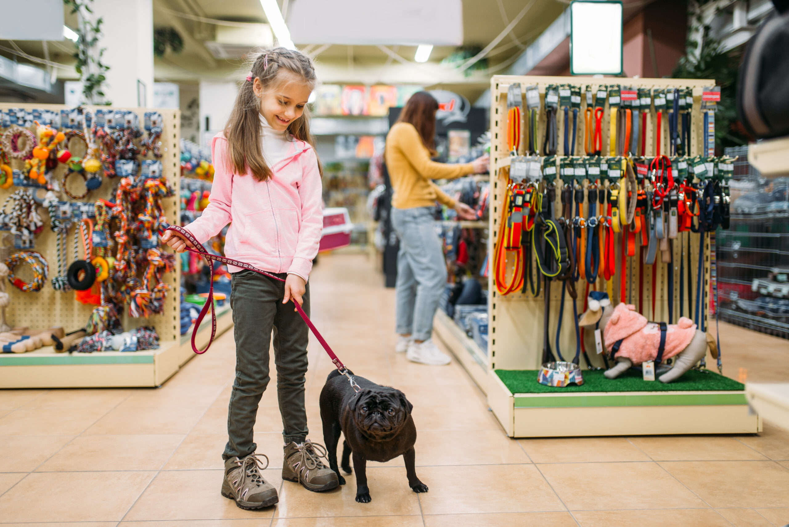little-girl-with-puppy-in-pet-shop-friendship-2021-08-26-16-26-06-utc-scaled.jpg
