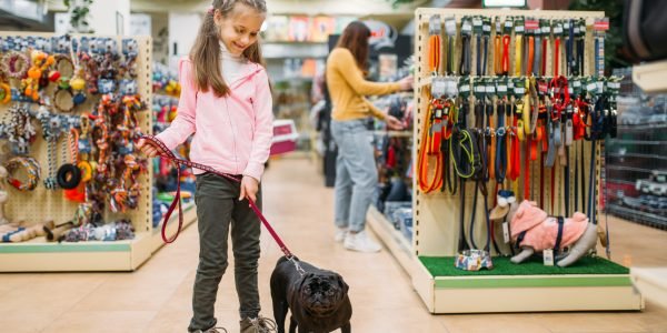 little-girl-with-puppy-in-pet-shop-friendship-2021-08-26-16-26-06-utc-scaled.jpg